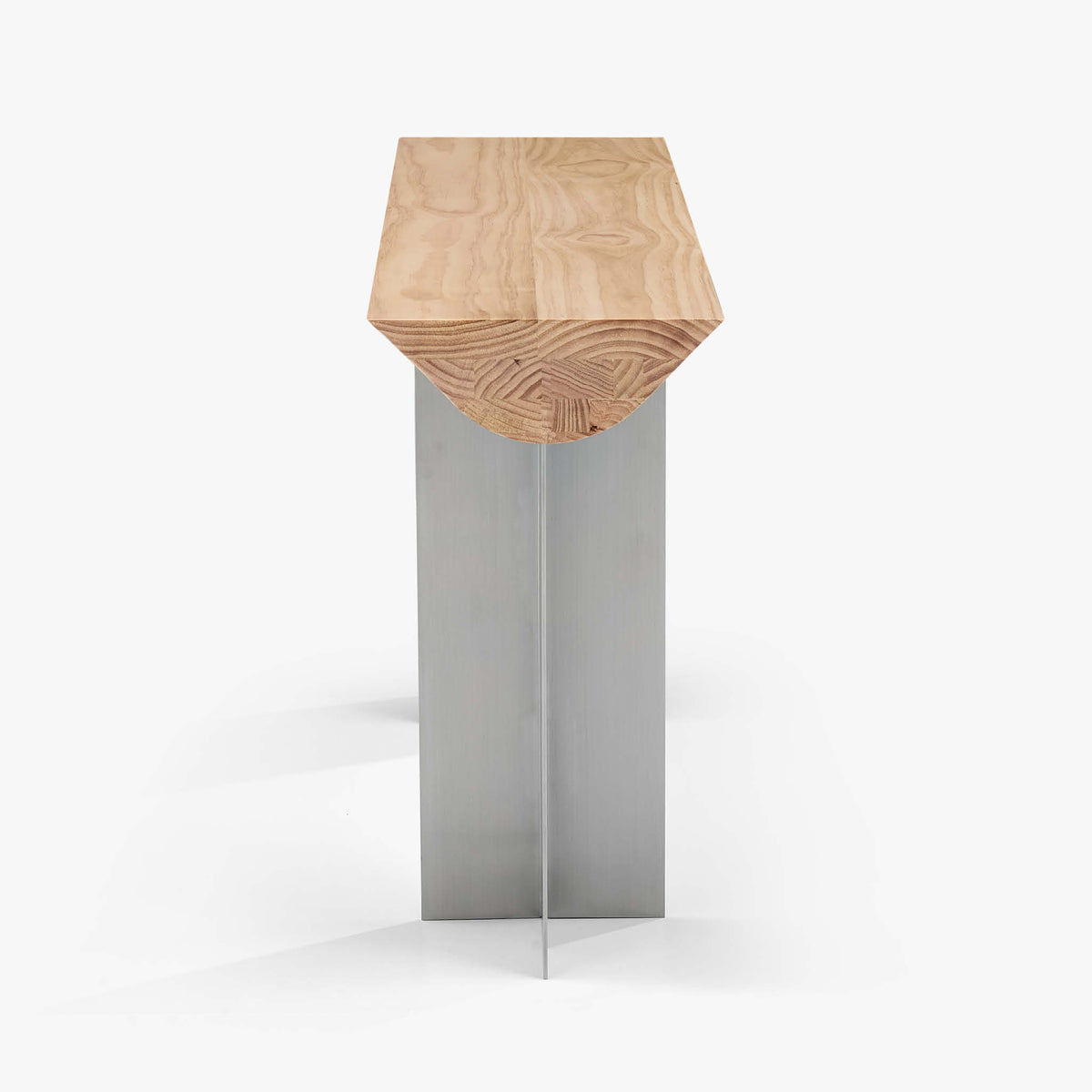 End view of the Forma Atelier console table showing the curved Douglas fir profile and slender stainless steel base.
