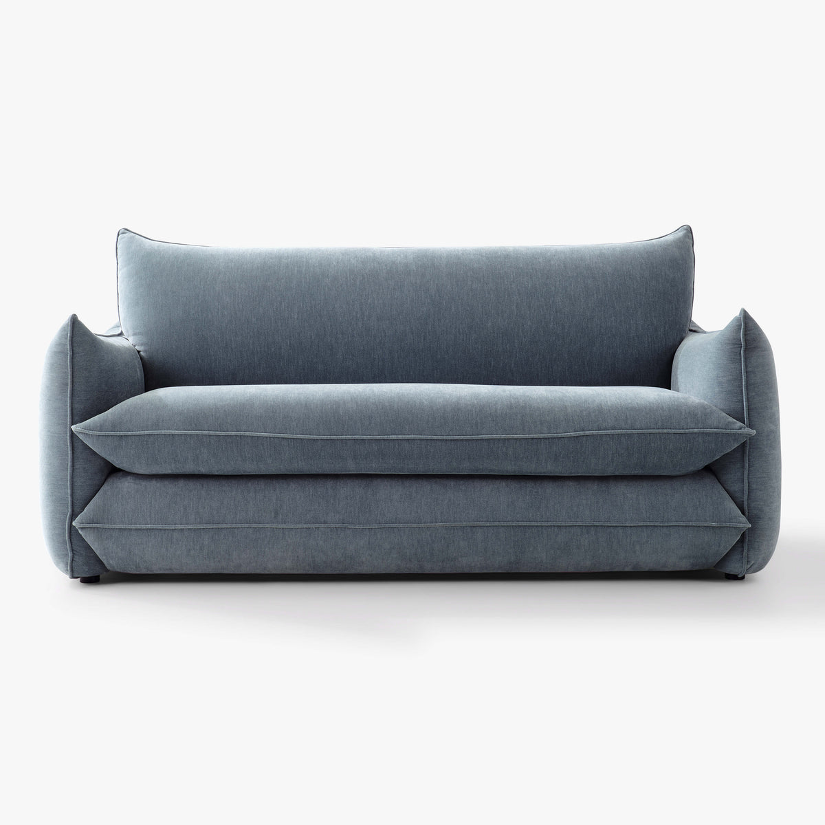Front view of the Blossom sofa bed in Celestine, showing its curved arms and upholstered seat and back cushions.