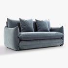 Angled front view of the Blossom sofa bed in Celestine with curved arms, back cushions and two decorative cushions.