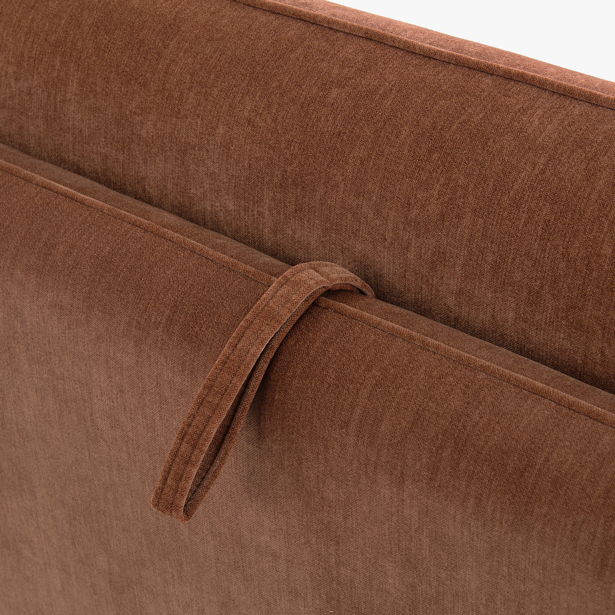 Close-up of the Blossom sofa bed in Bronze, showing the fabric pull loop and stitched upholstery.