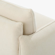 Close-up of the Blossom sofa bed in Bisque, showing the curved arm, cushion edges and stitched upholstery detail.