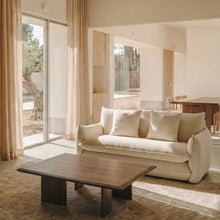 Blossom sofa bed in Bisque with curved arms and matching cushions, styled in a sunlit living room.