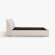 Side view of the Dormi queen bed frame in Bluff upholstery.