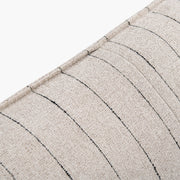 Detail of the Dormi bed’s Cobblestone striped upholstery and stitched edge.