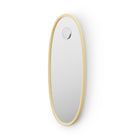 Oval shaped mirror with butter yellow frame on a white background