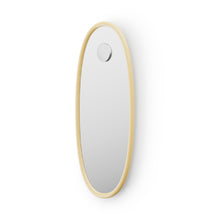 Oval shaped mirror with butter yellow frame on a white background
