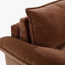 Close-up of the Ease sofa bed in Bronze, showing the cushioned arm, back cushion and stitched upholstery edges.