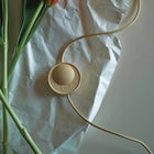 Beige electronic lamp controller with  the cord on crumpled white paper