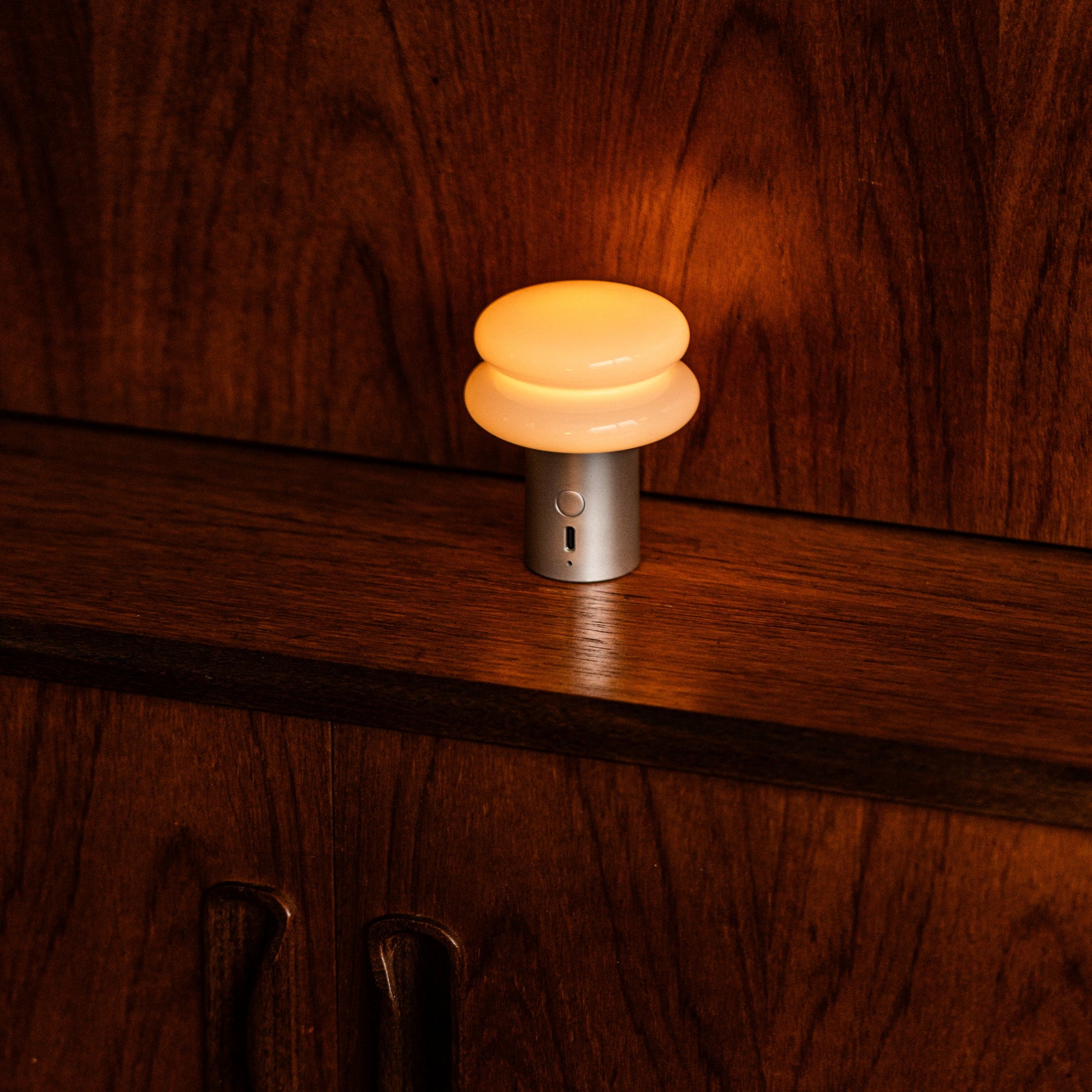 Turned on lamp on a wooden surface
