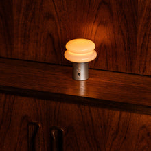 Turned on lamp on a wooden surface