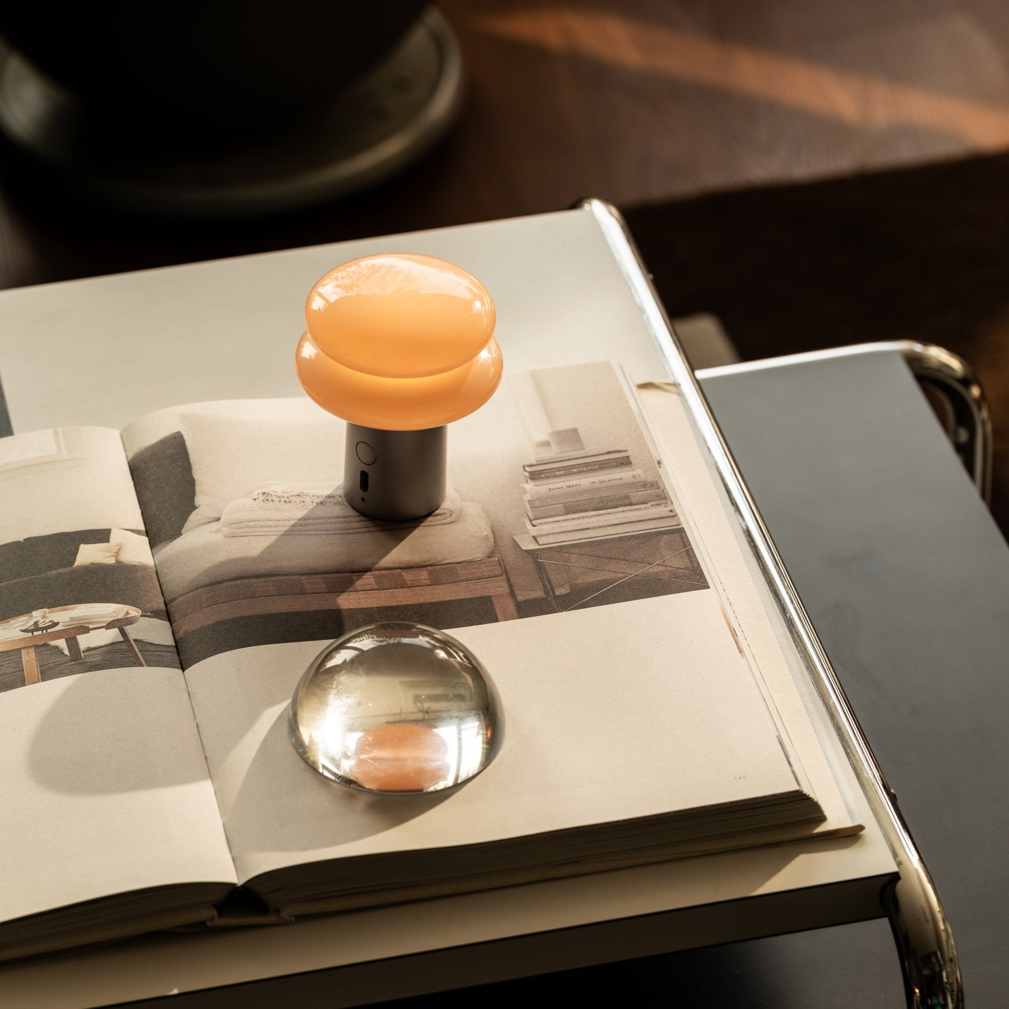 Decorative objects and a lamp on an open book with a blurred background