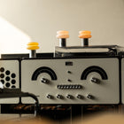 Vintage-style radio with three portable lamps on a neutral background