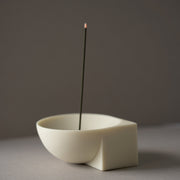 Butter LUME resin incense holder with a single incense stick on a grey background.