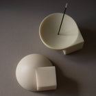 Two resin objects on a grey surface