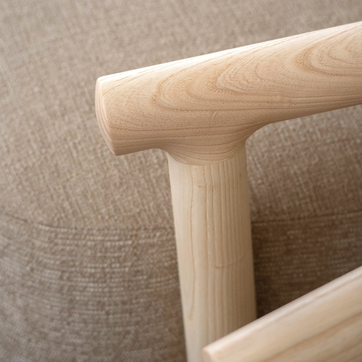 Marlene Armchair beige upholstery and dark timber arms, side profile
