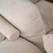 RUE sofa in Butter upholstery, close-up of loose back cushion and cylindrical bolster
