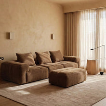 RUE 3-seat modular sofa with ottoman in Tundra upholstery, styled in a warm living room