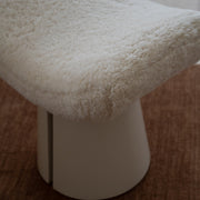 Close-up of Sela Stool natural lambswool upholstery and high-gloss Bone timber base