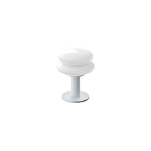 White shade and pale blue base portable table lamp on a white background