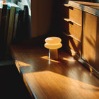 Wooden desk with a small lamp and books in a cozy room