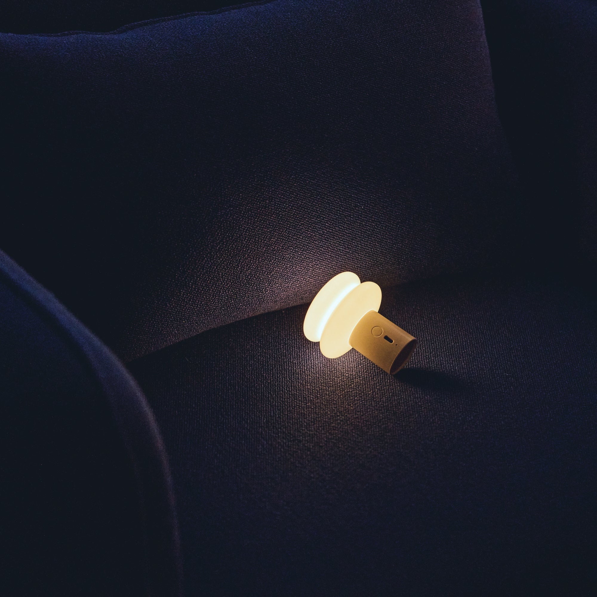 Small lamp on a dark fabric surface