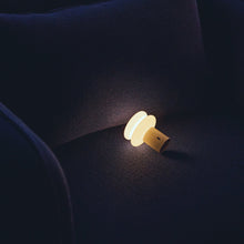 Small lamp on a dark fabric surface