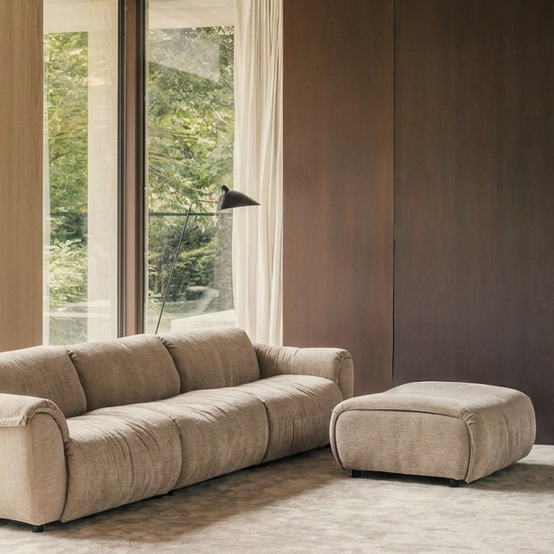 SOLACE 3-seat modular sofa and ottoman in River Clay upholstery in a warm modern living room