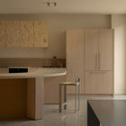 Tira Barstool beside a curved kitchen island in a light timber interior