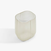 Angled view of the VETRO hand-blown glass side table in Opaline, showing its pale translucent finish and softly rounded shape.